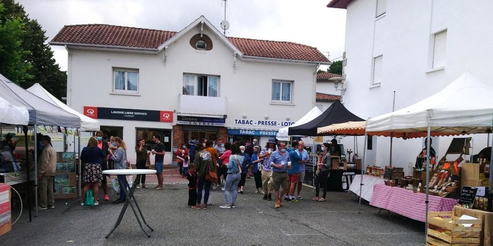 Saturday market stalls in front of the village shops